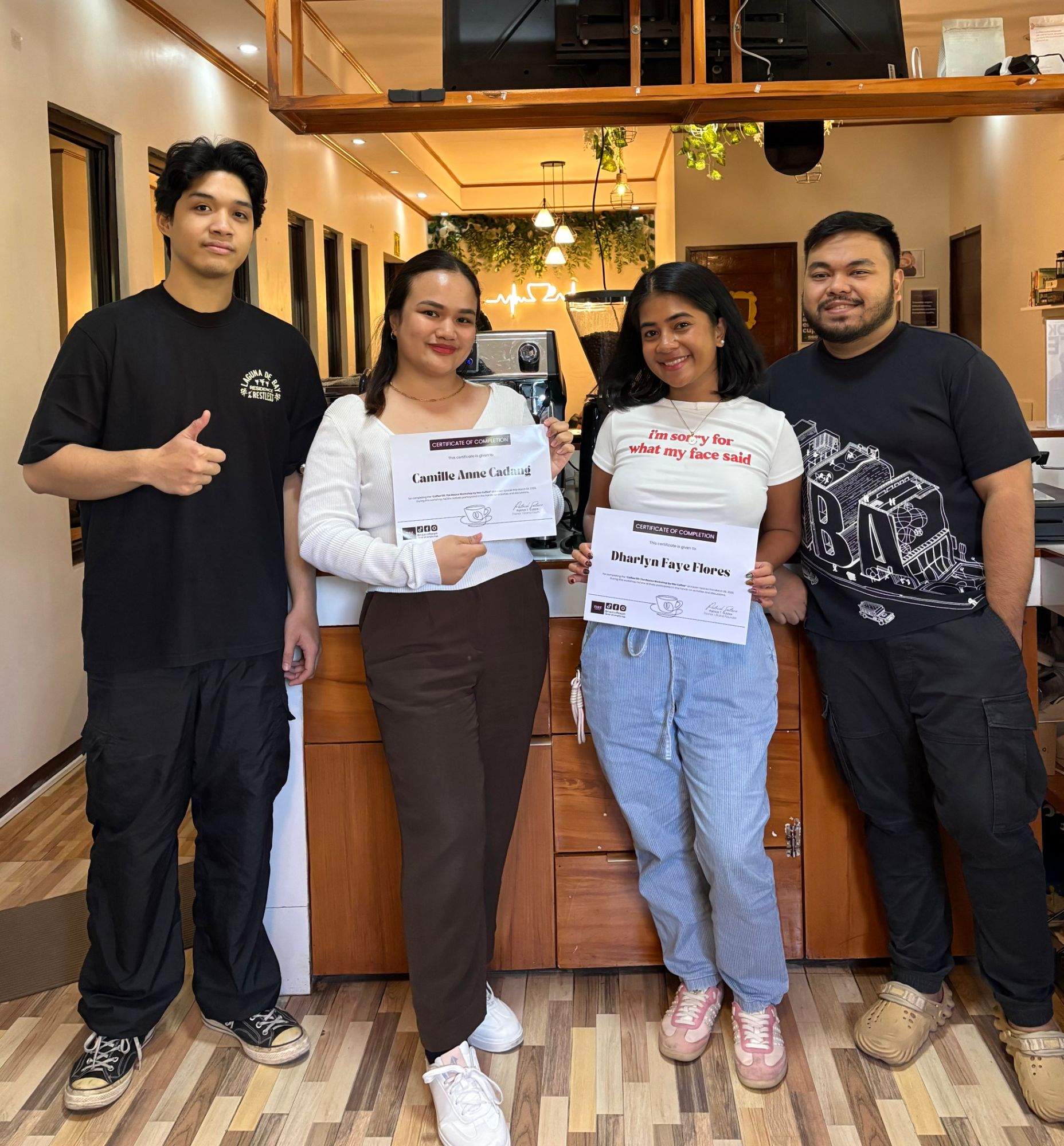 Coffee 101 workshop graduates holding their certificates of completion