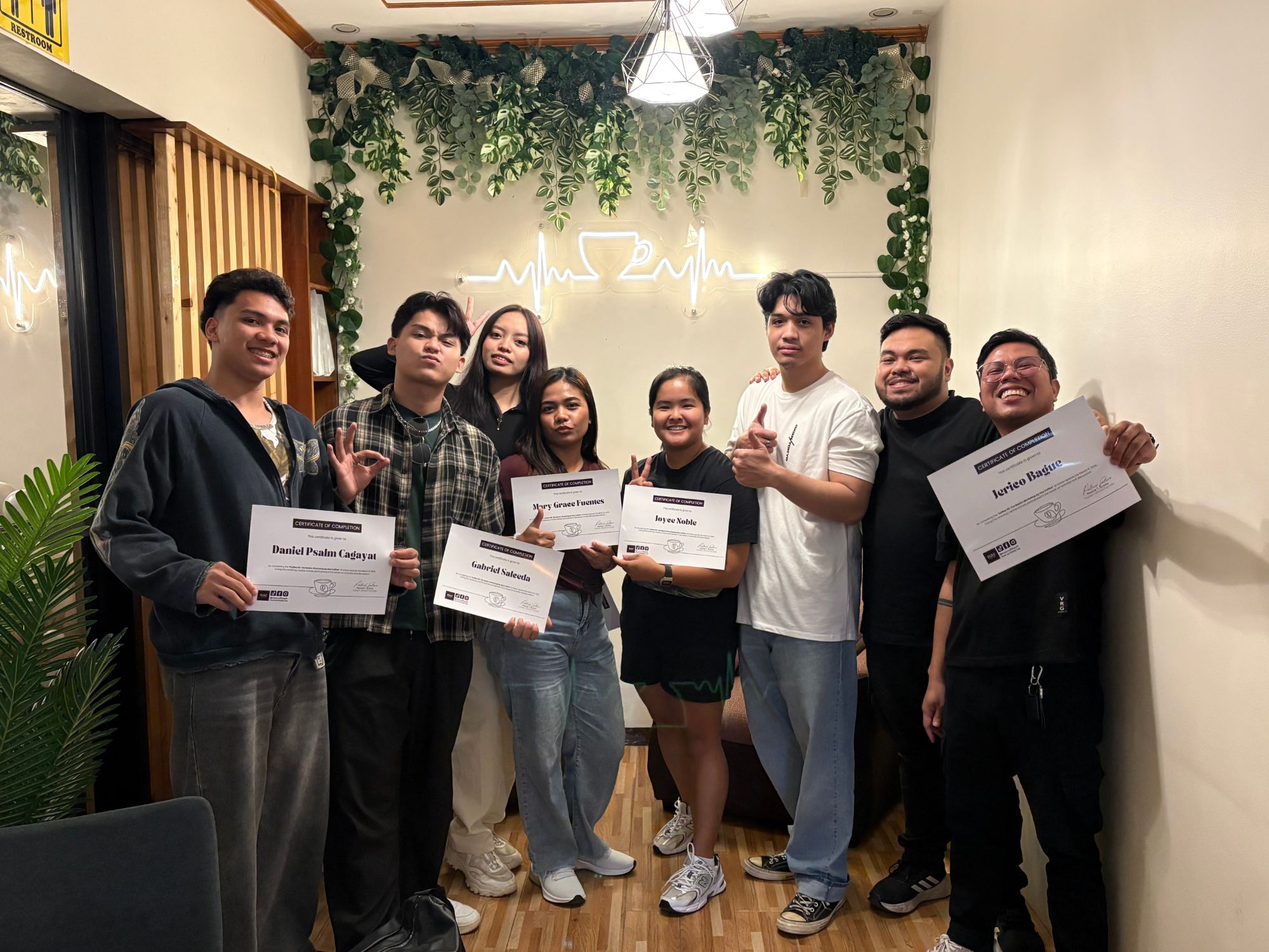 Coffee 101 workshop graduates holding their certificates of completion