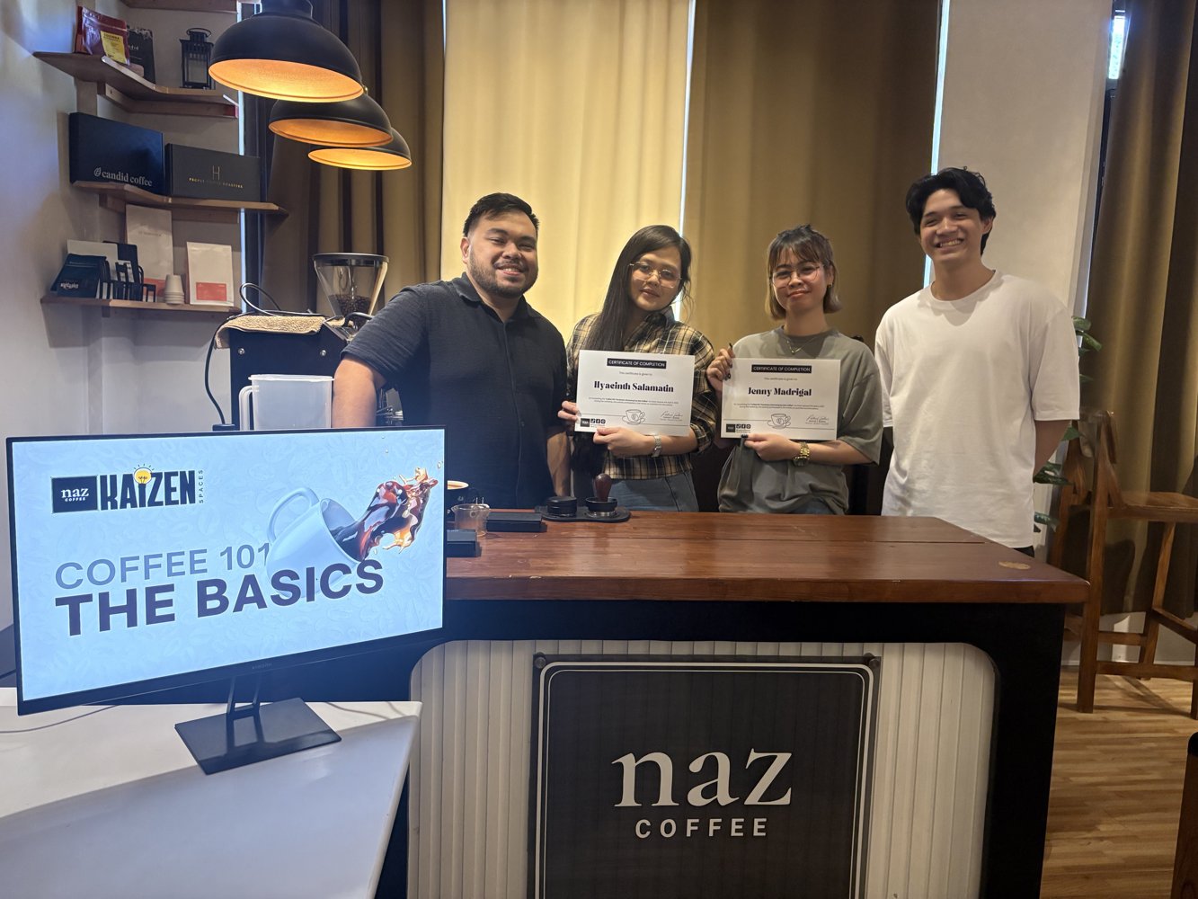 Coffee 101 workshop graduates holding their certificates of completion